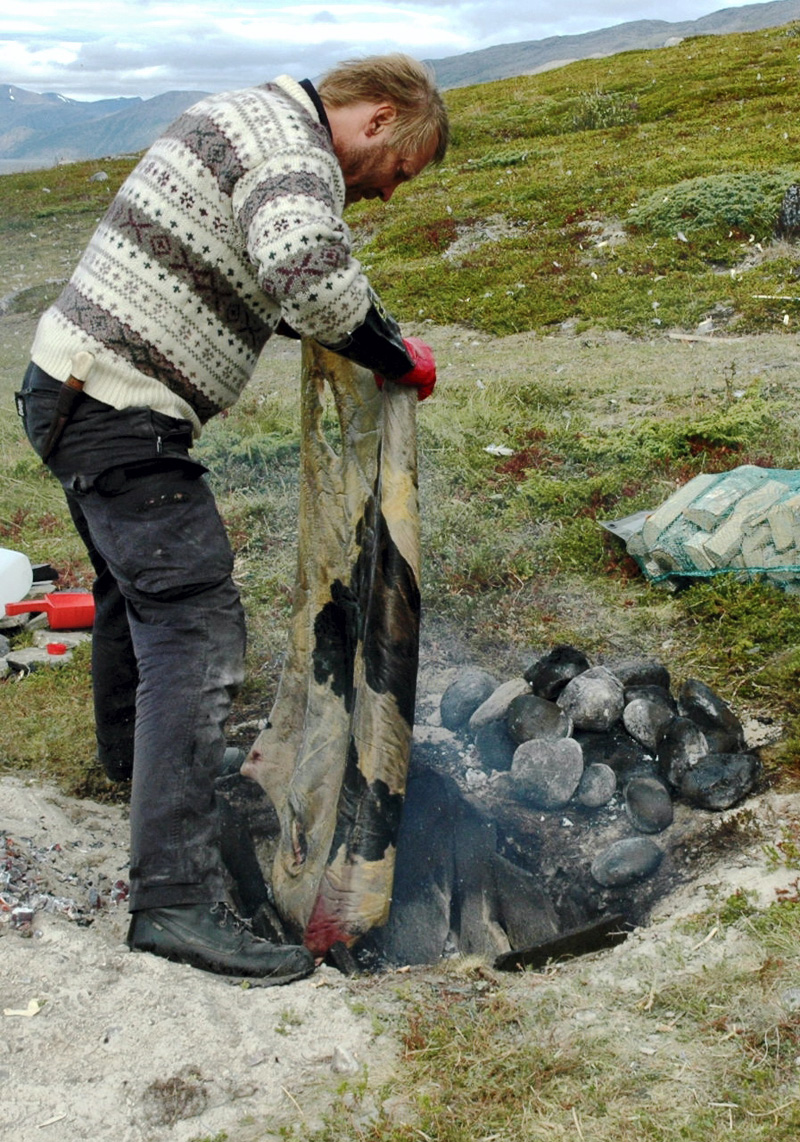Lars Erik Normo legger skinn ned i hellegropa.